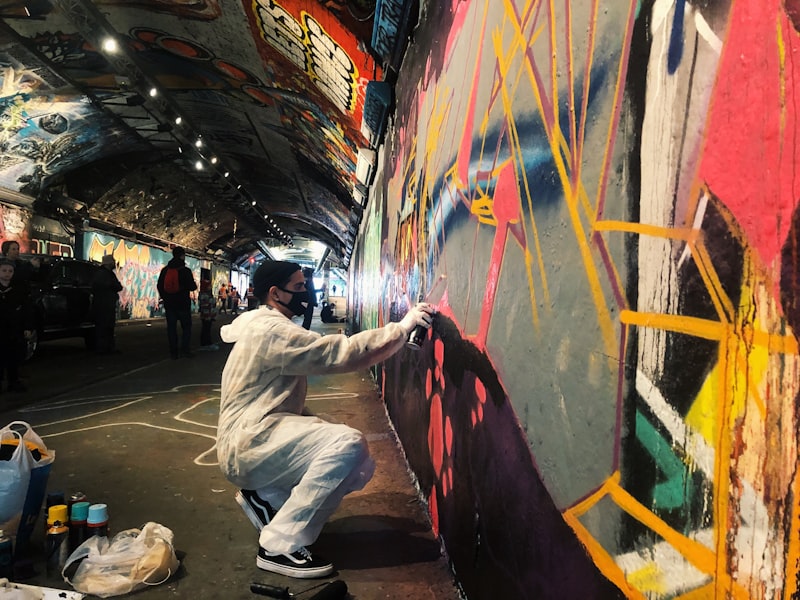 Graffiti-covered tunnel wall in Shoreditch, East London, with vibrant street art
