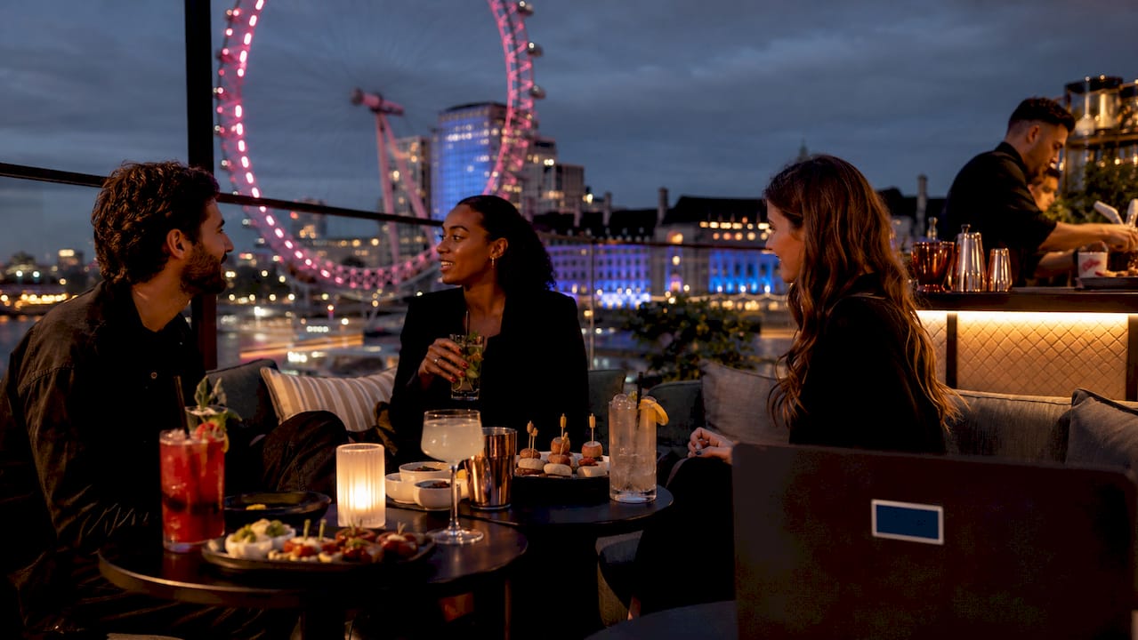 Rooftop party with Tower Bridge view at dusk