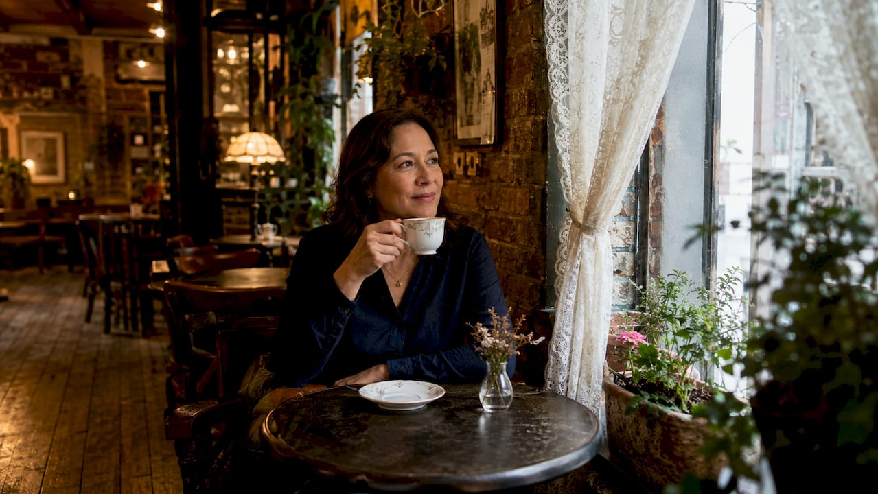 Interior of a historic style London café with natural light and coffee drinker